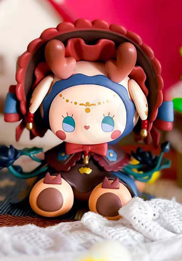 Colorful figurine with decorative elements on a textured surface