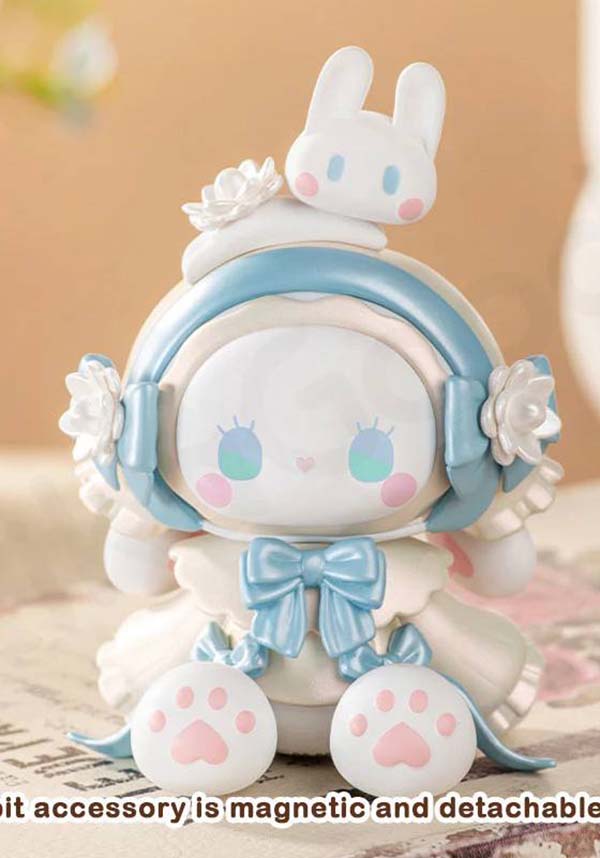 Cute character figurine with bunny ears and bow tie on a beige background