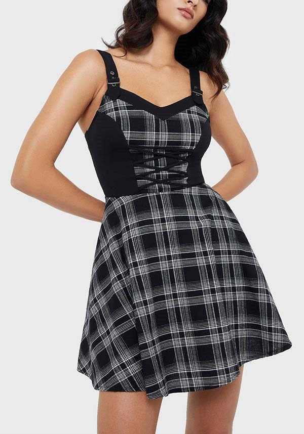 Black and white plaid dress worn by a model on a white background