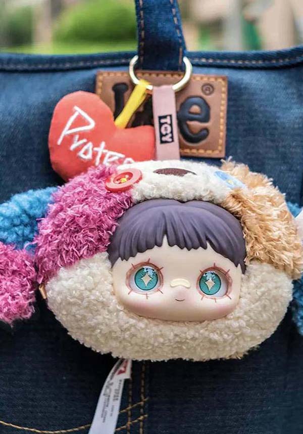 Plush keychain with cartoon character on a denim bag