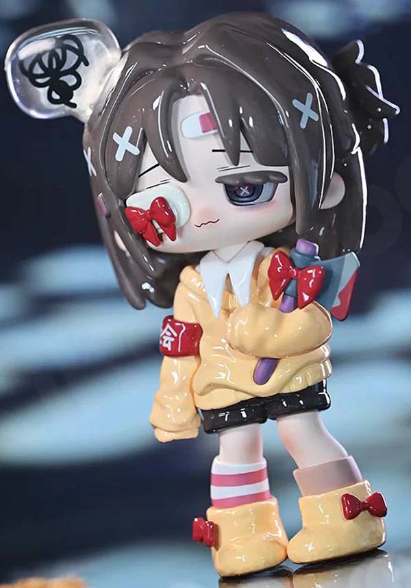 Animated character figurine with distinctive style and accessories on a blurred background