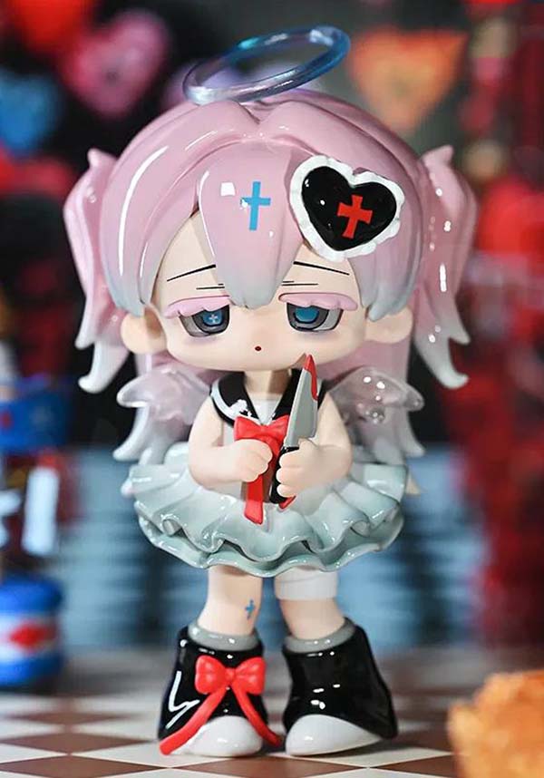 Toy figure with pink hair and a heart symbol, holding a knife, against a colorful background.