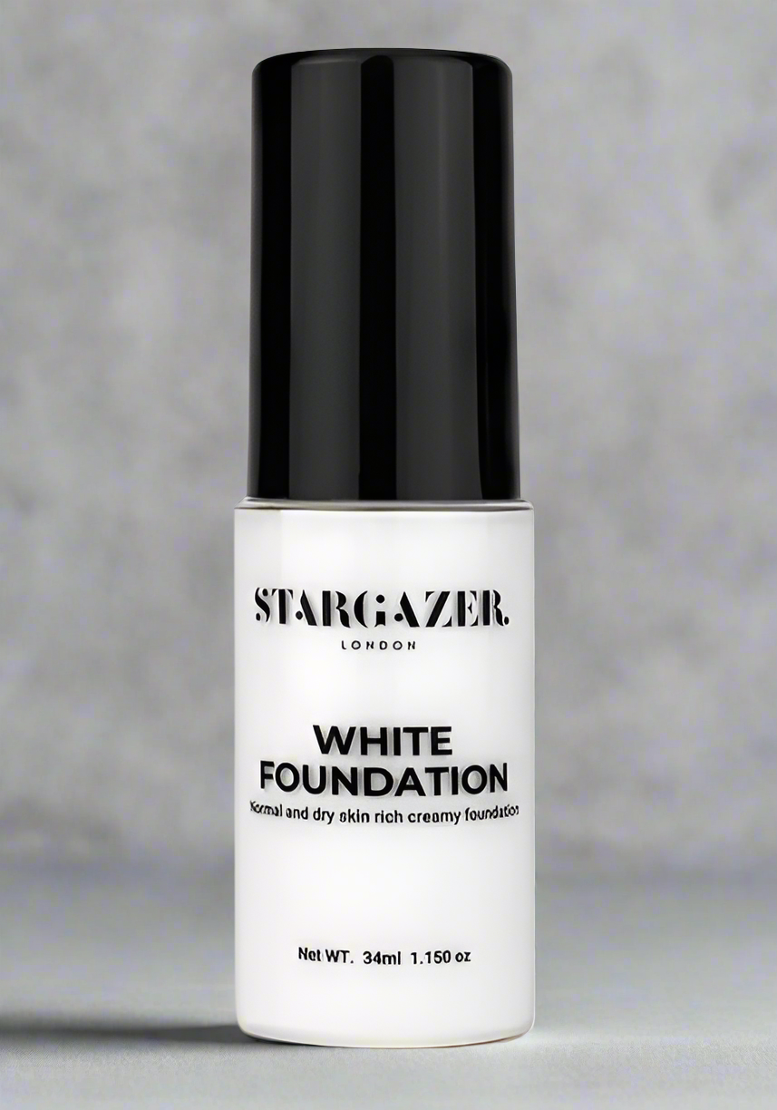 A bottle of Stargazer white Liquid foundation with a black cap. The foundation is designed for providing strong, long-lasting coverage with a smooth creamy texture.