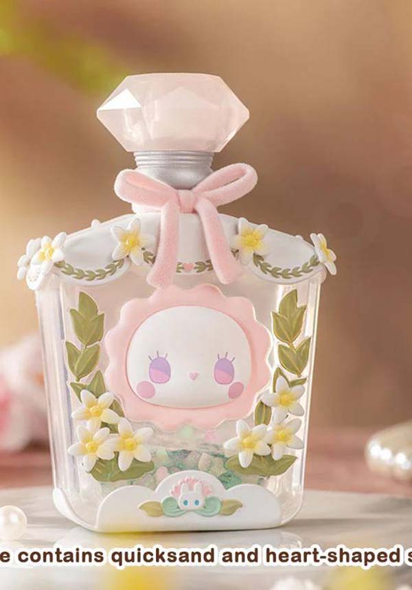 Cute, decorative bottle with a cartoon character and floral design on a blurred background
