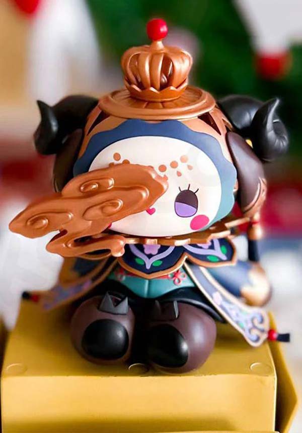 Colorful figurine with a decorative hat on a yellow stand