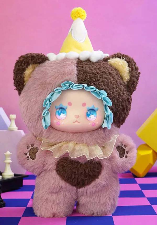 Colorful plush toy with a checkered floor and pink background