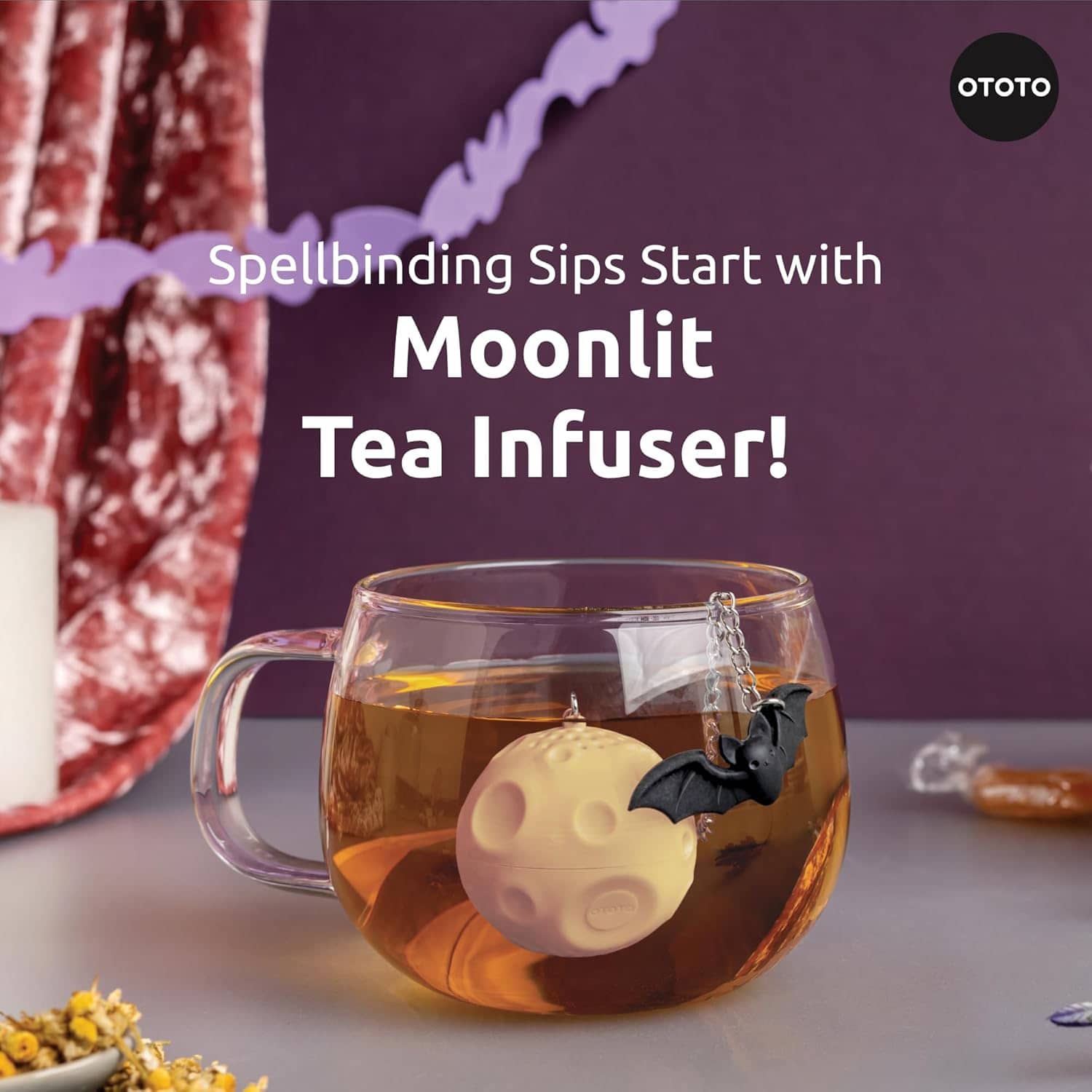 Ototo Moonlit Tea Infuser - Halloween lifestyle shot steeping in glass mug, dark purple background